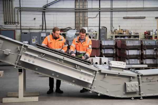 project managers checking conveyors